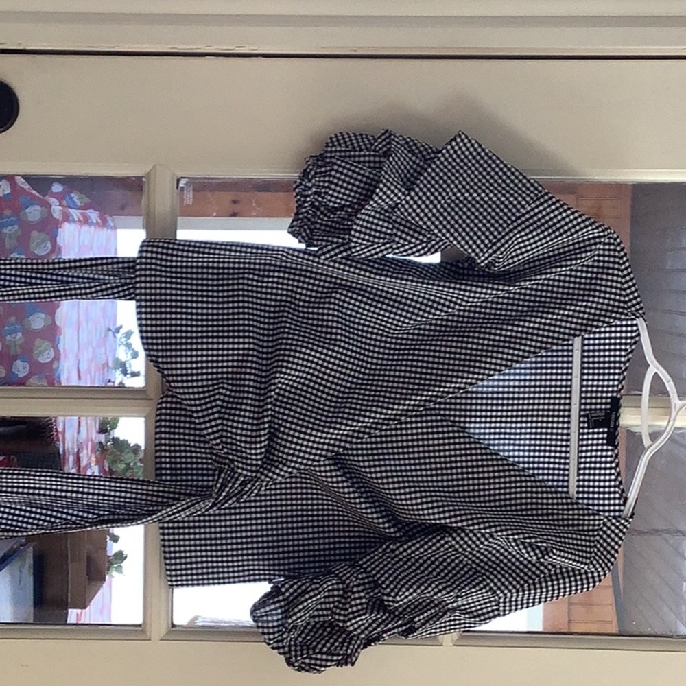 Wrap around black and white check blouse with ruffled sleeves